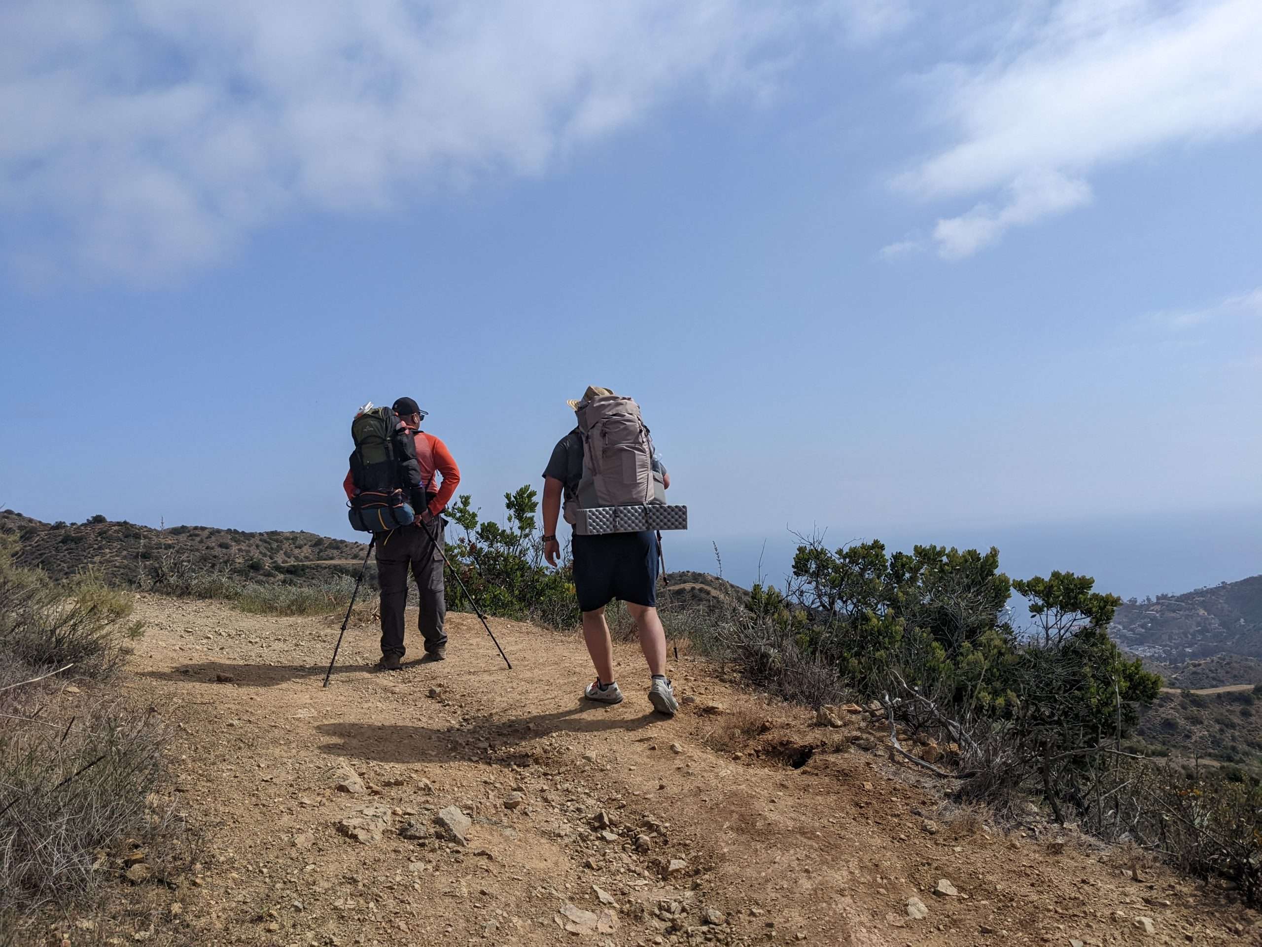 Two hikers stopping for a moment on the trail.