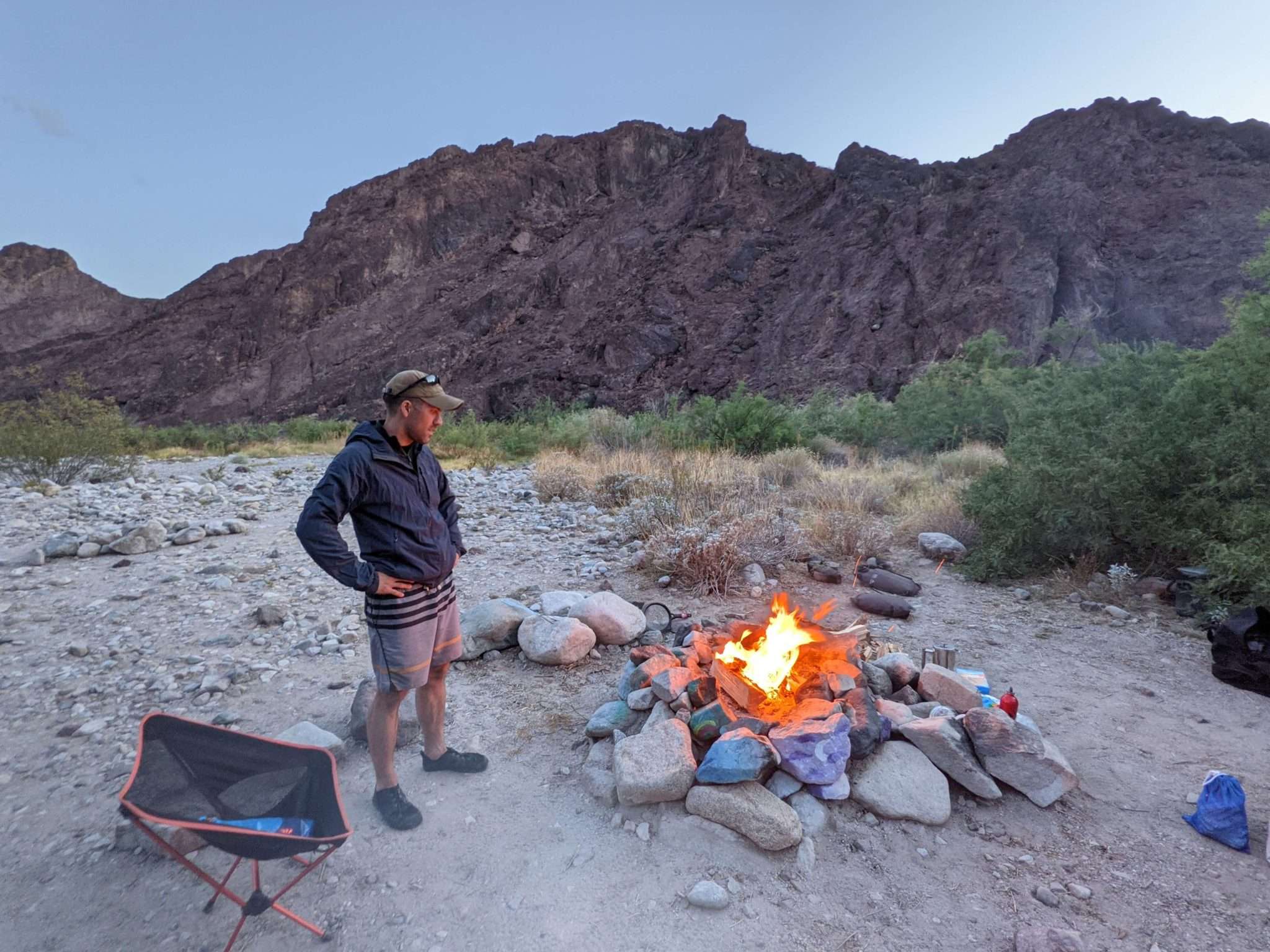 leadership presence begins with being present. Leader by a campfire.