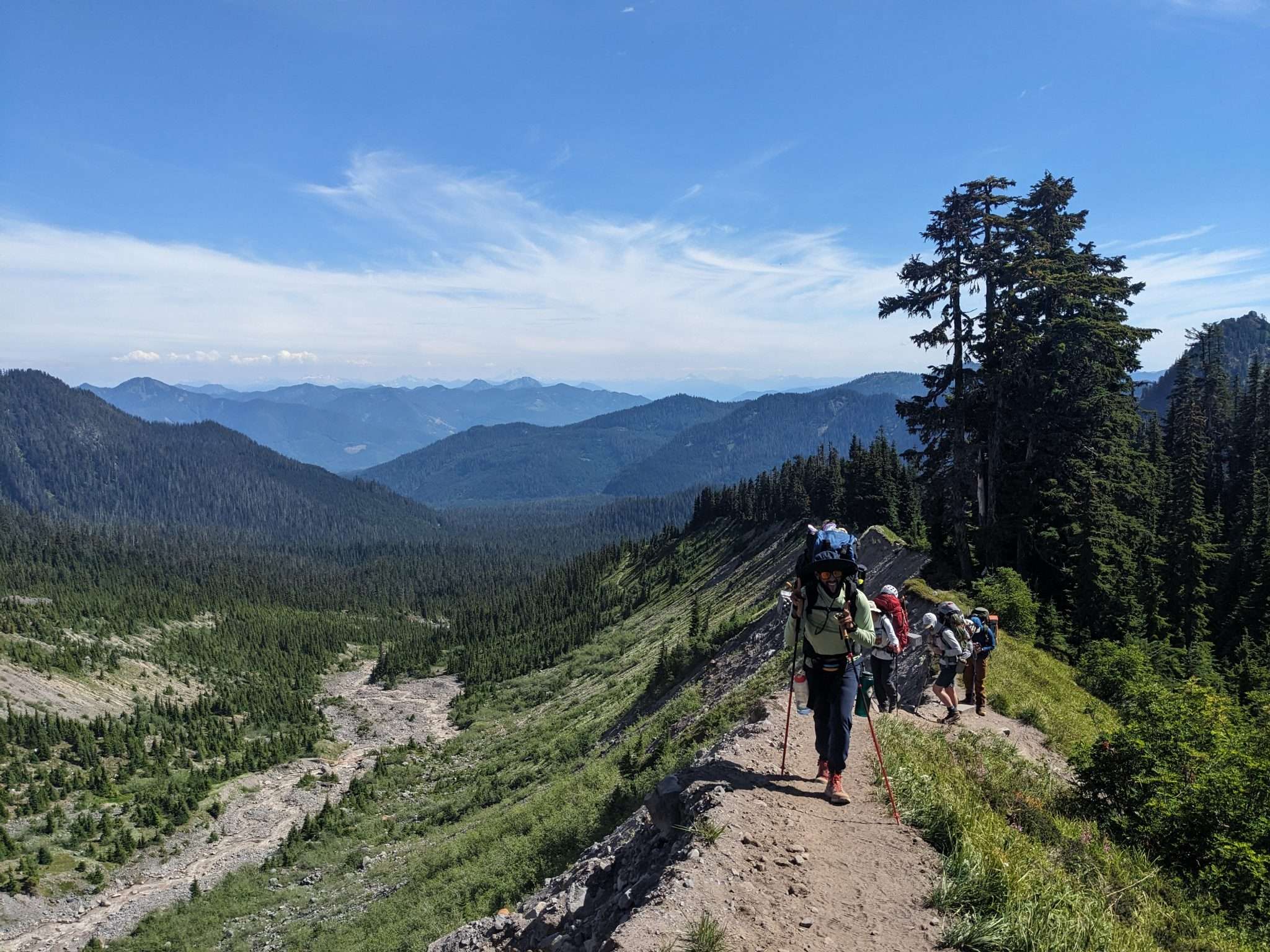 Leaders cresting a hill on Mt Baker Leadership Summit