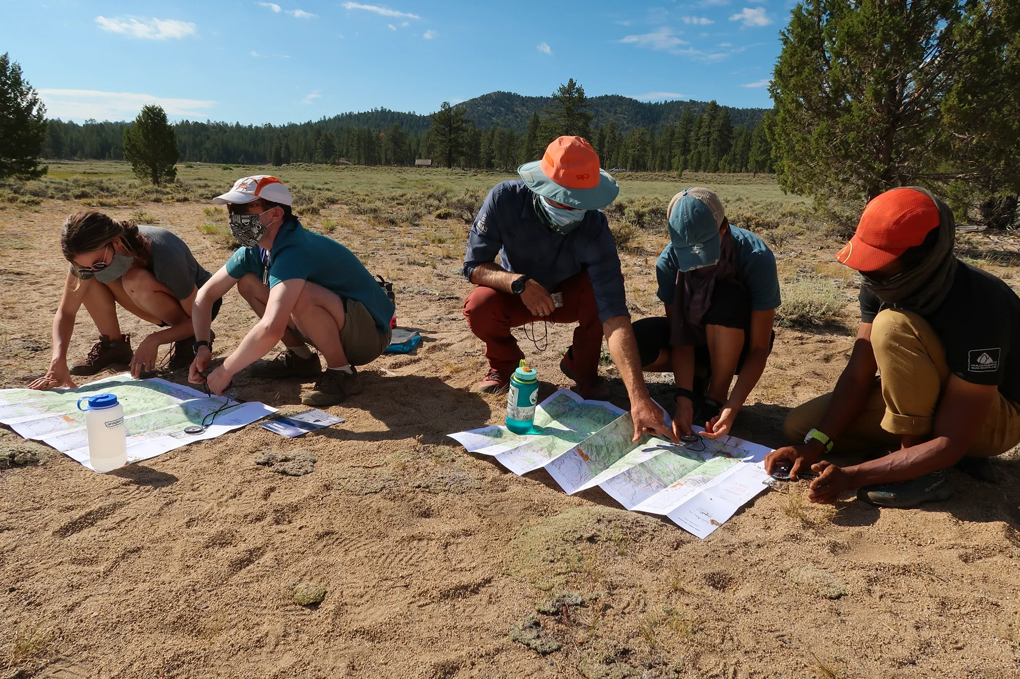 Cairn Leadership instructors teaching clients how to navigate in the outdoors and the value of skill building and teamwork.
