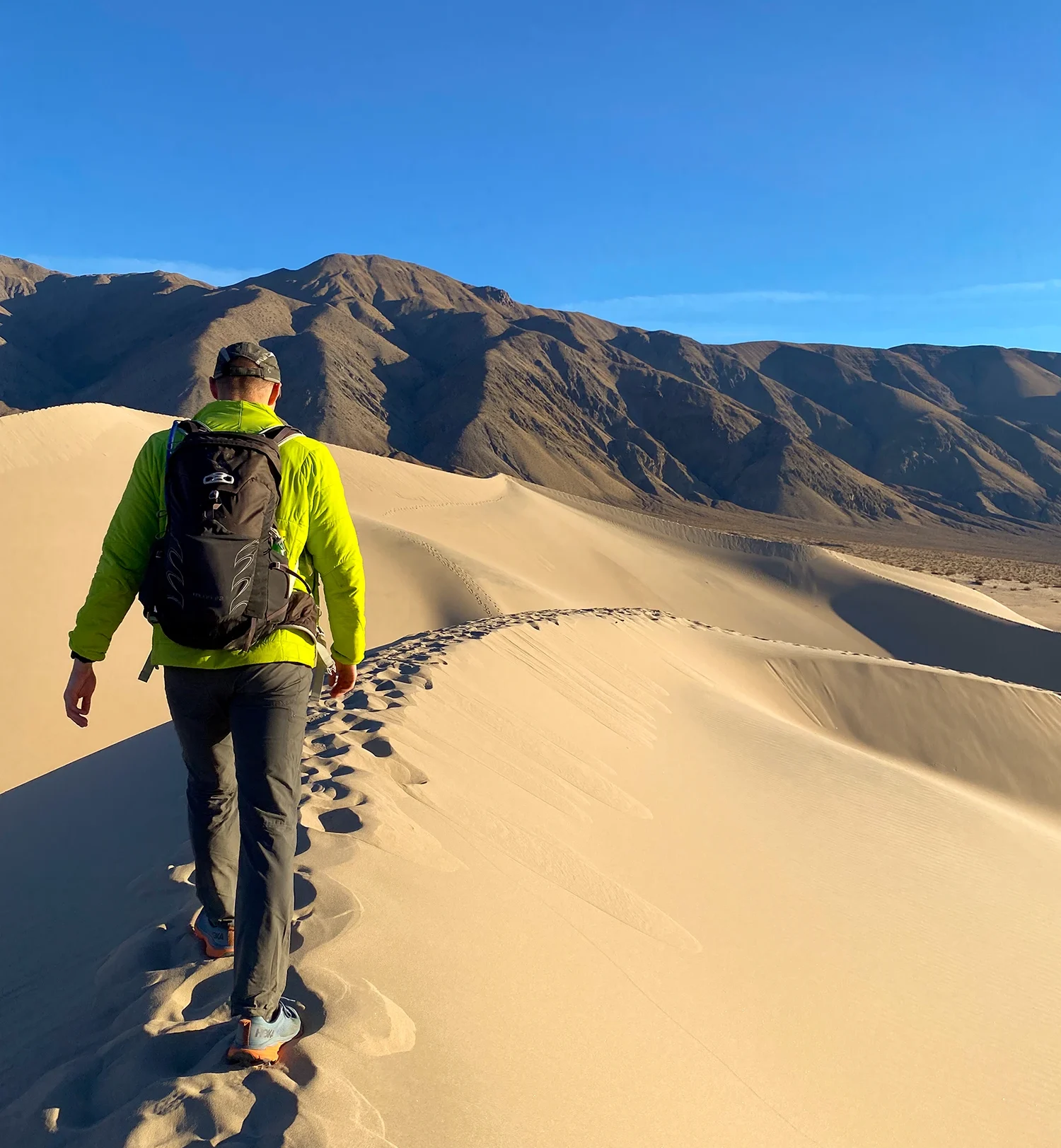 A man learning to explore nature and navigate his path in a sandy desert.