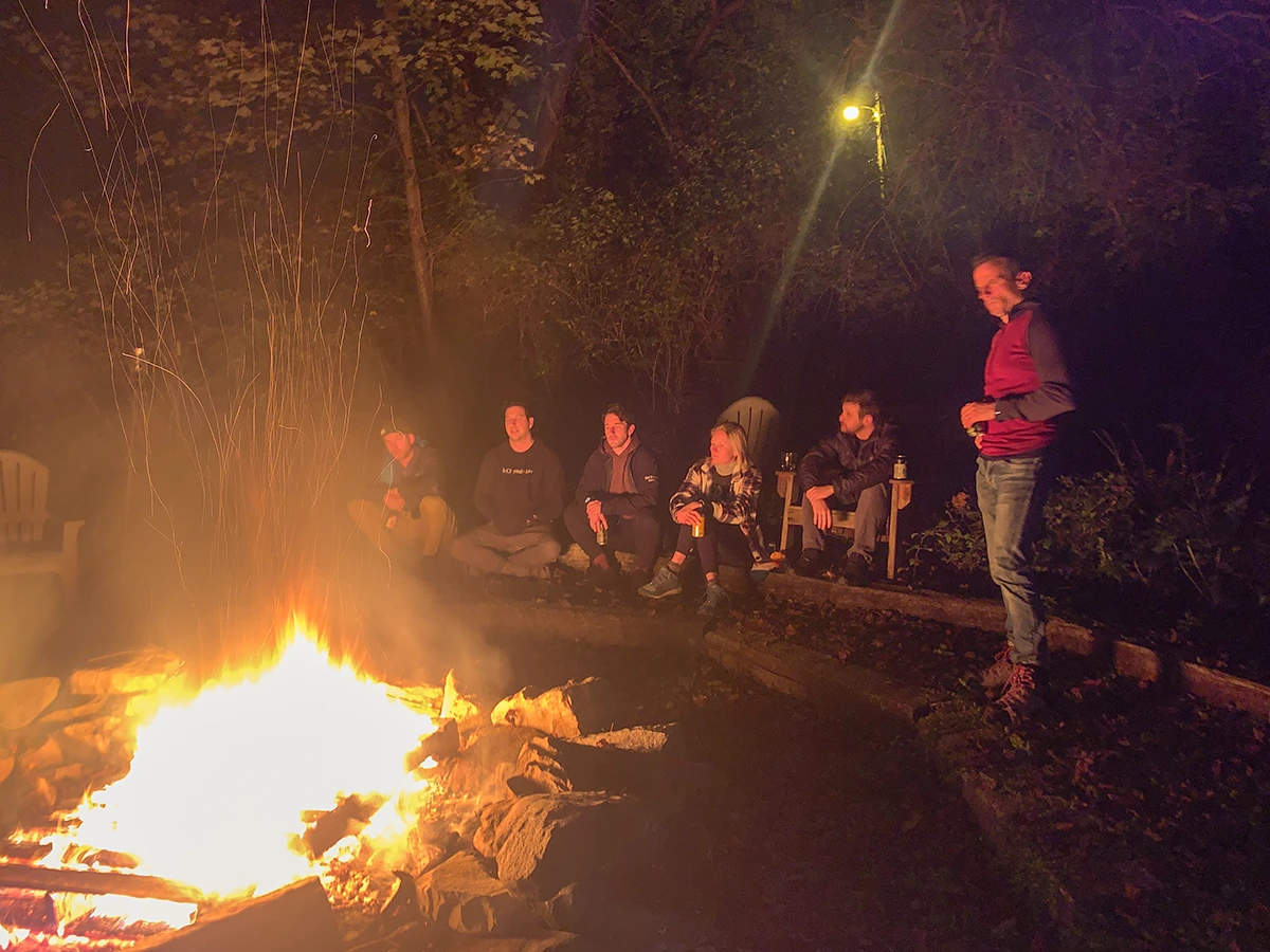 A connected remote team building connections around a campfire.
